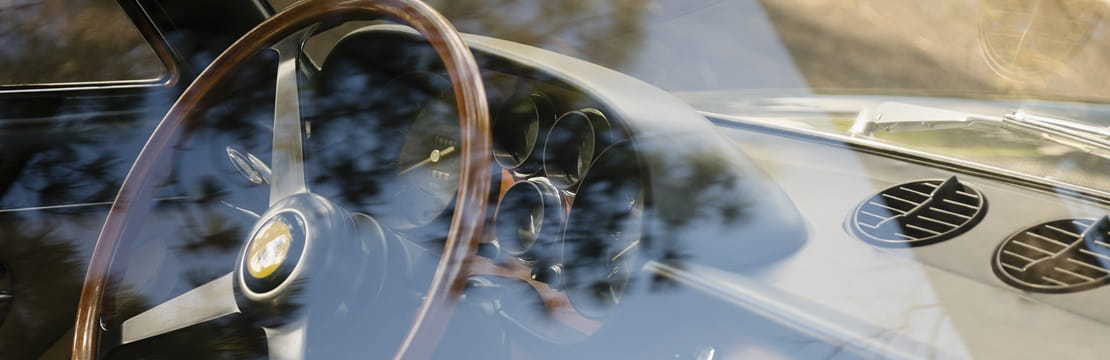 Vintage car dashboard viewed through window